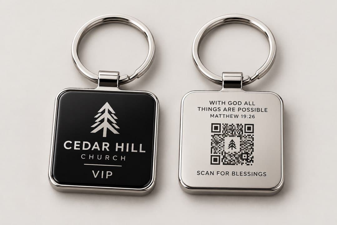The front of a key tag with an engraved church logo, and the back with a Bible verse and a scan code.